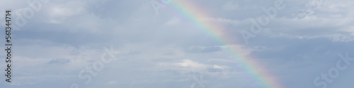 4x1 banner with a rainbow in the cloudy sky after the rain
