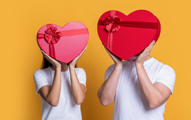 couple in love hold valentine present isolated on yellow. couple with valentine love present