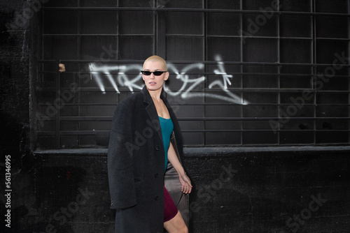 Young and Rebellious Citizen with Short Blonde Hair and Dark Glasses Roams the Back Alleys of Downtown Los Angeles.