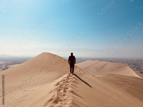 A man stopped on a dune in the desert. Huacachina  Peru