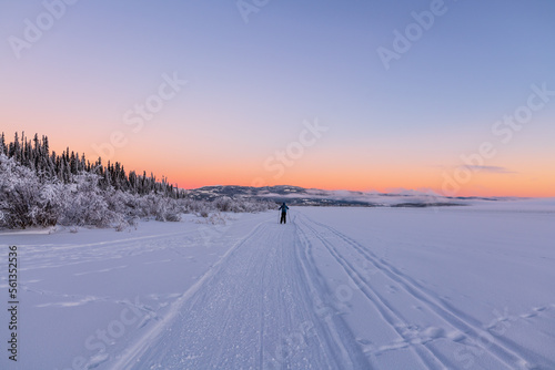 Incredible landscape views during winter with one person skiing, pastel sunset wilderness views. 