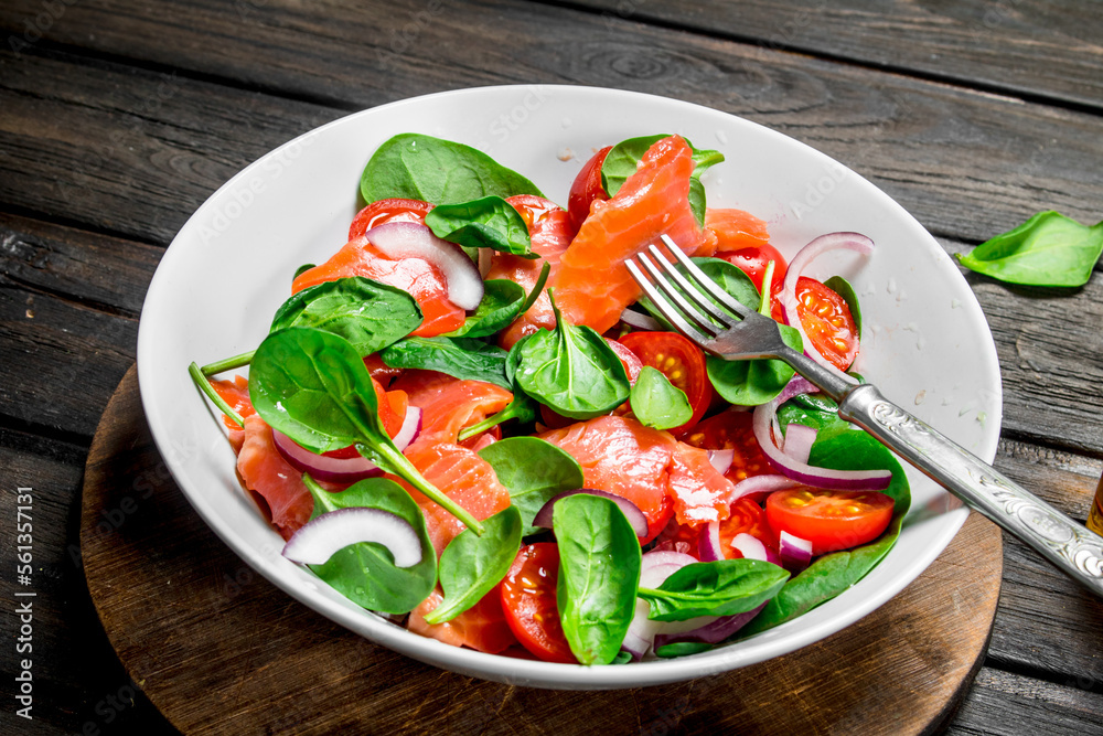 Fish salad. Salad with slices of salmon, tomatoes and spinach with lime juice. Fish salad. Salad with slices of salmon, tomatoes and spinach with lime juice.