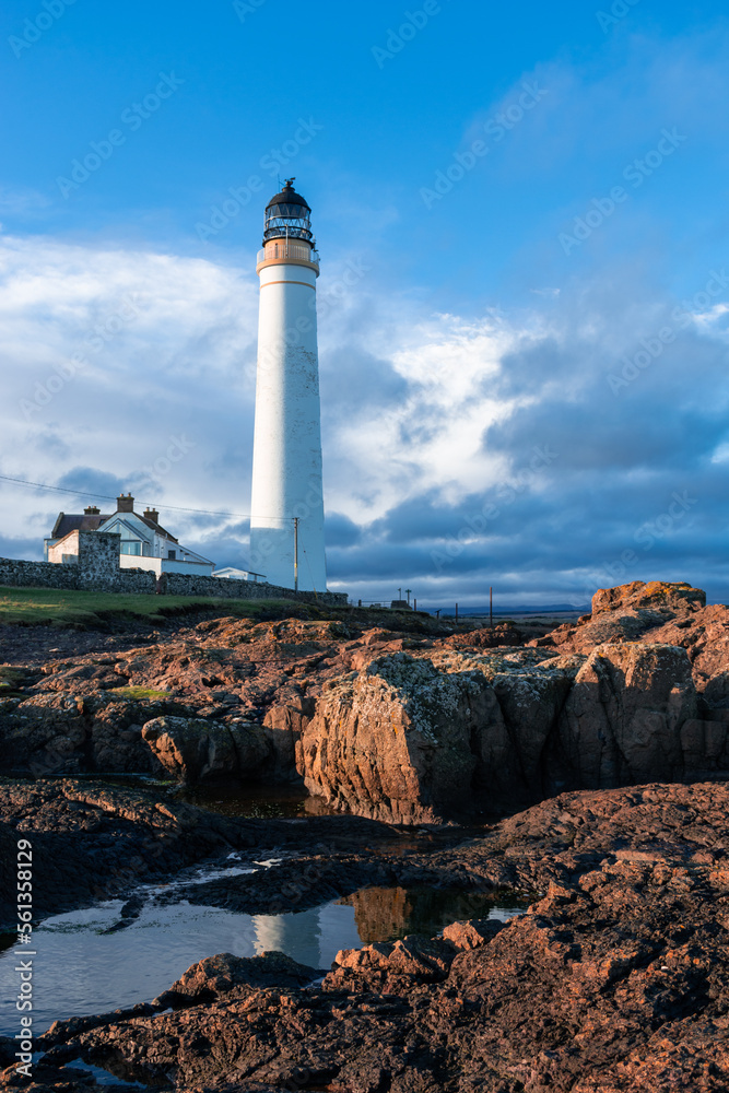 Lighthouse on the coast of the North Sea in Scotland against a dramatic sky