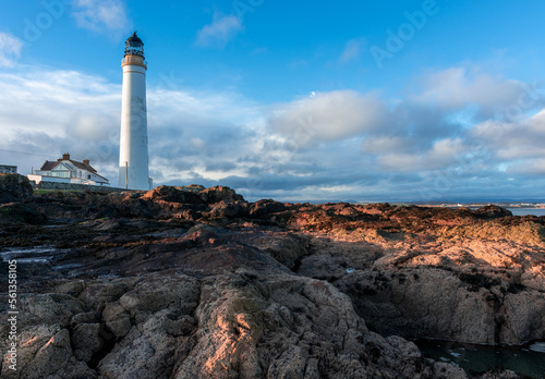 Lighthouse on the coast of the North Sea in Scotland against a dramatic sky