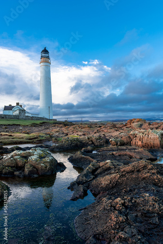 Lighthouse on the coast of the North Sea in Scotland against a dramatic sky