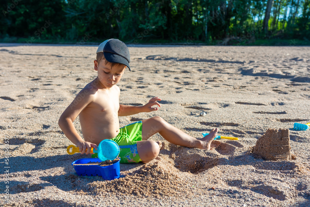 little boy on the beach playing in the sand little boy on the beach playing in the sand