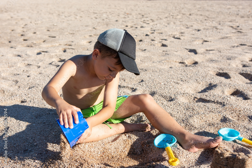 little boy on the beach playing in the sand little boy on the beach playing in the sand