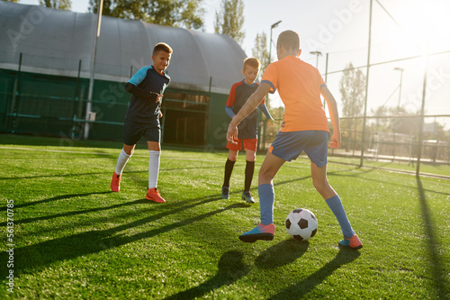 Young boys in sports soccer club on training unit improving skills