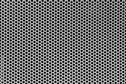 Metal grid background, speaker close-up. A steel grill with small holes full screen, ideal for dj and music events advertising.