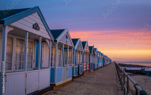 Colourful beach huts on the promonade by the pier in Southwold, Suffolk at sunrise photo