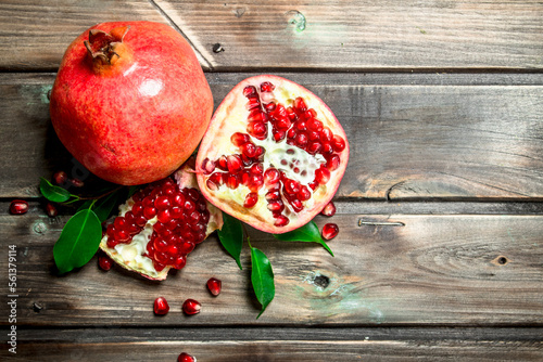 Fresh juicy pomegranate with leaves.