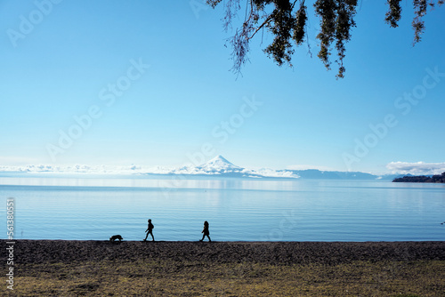 Wallpaper Mural Shape people and dog walking in the border of a lake with cloudy volcano in the backgroun Torontodigital.ca