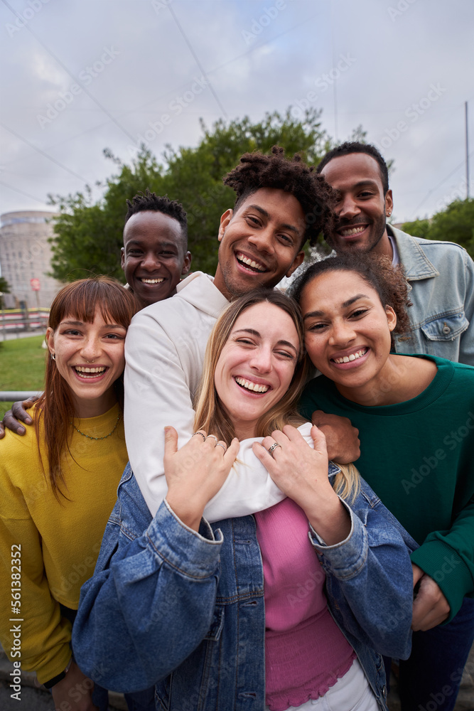 © CarlosBarquero - Vertical selfie of Young people embrace posing for a group portrait looking at the camera outside. Smiling friends of the millennial generation. Young guys and girls having fun together © CarlosBarquero - Vertical selfie of Young people embrace posing for a group portrait looking at the camera outside. Smiling friends of the millennial generation. Young guys and girls having fun together