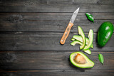Avocado and small slices of avocado with a knife.