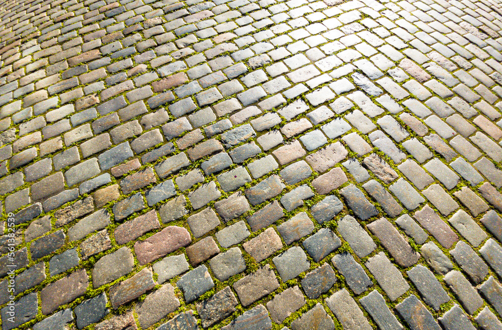 Granite dirty paving stones in the city. Road from paving stones for background and texture. The old road of granite paving stones Granite dirty paving stones in the city. Road from paving stones for background and texture. The old road of granite paving stones