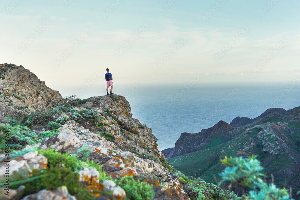 a person at the top of a mountain, ocean view northern Tenerife, Anaga mountains