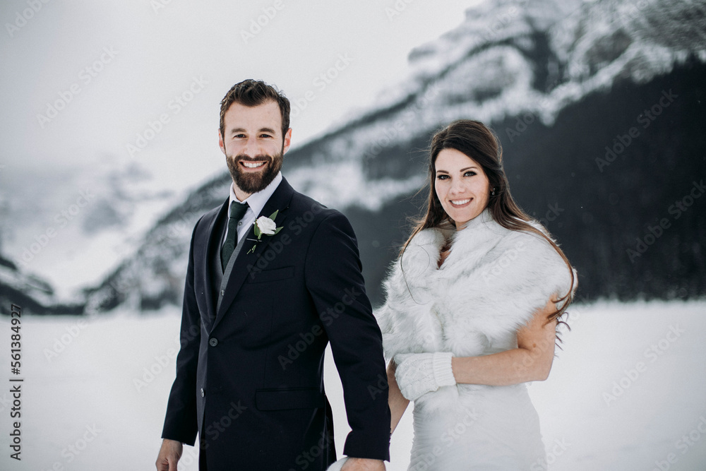 caucasian couple in wedding attire just married in winter in mountains caucasian couple in wedding attire just married in winter in mountains