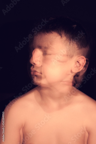 portrait of a child with several coloured gels on a black background w photo