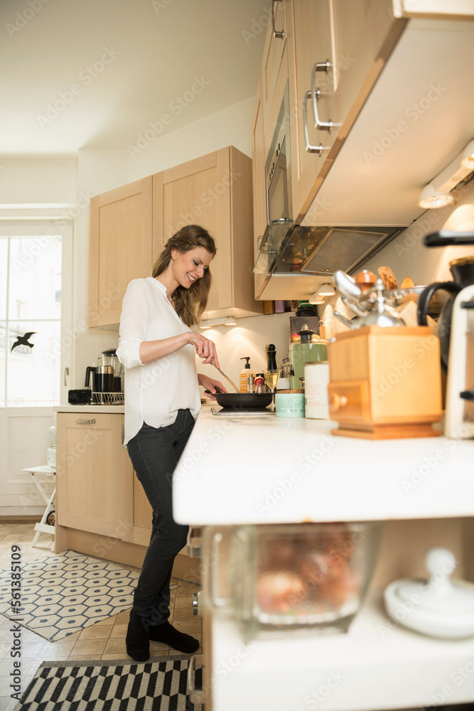 Young woman preparing food in kitchen, Munich, Bavaria, Germany Young woman preparing food in kitchen, Munich, Bavaria, Germany