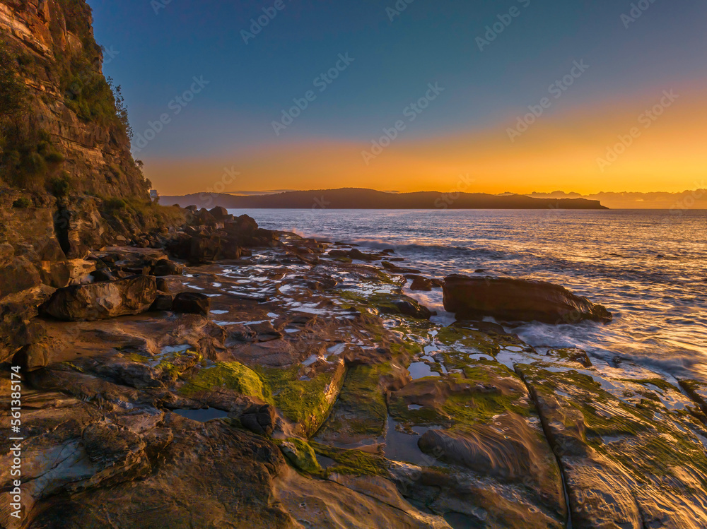 Fototapeta premium Aerial sunrise seascape with clear skies and low cloud bank