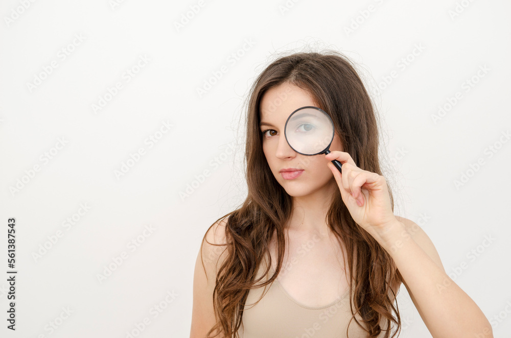 a woman looking through a magnifying glass a woman looking through a magnifying glass