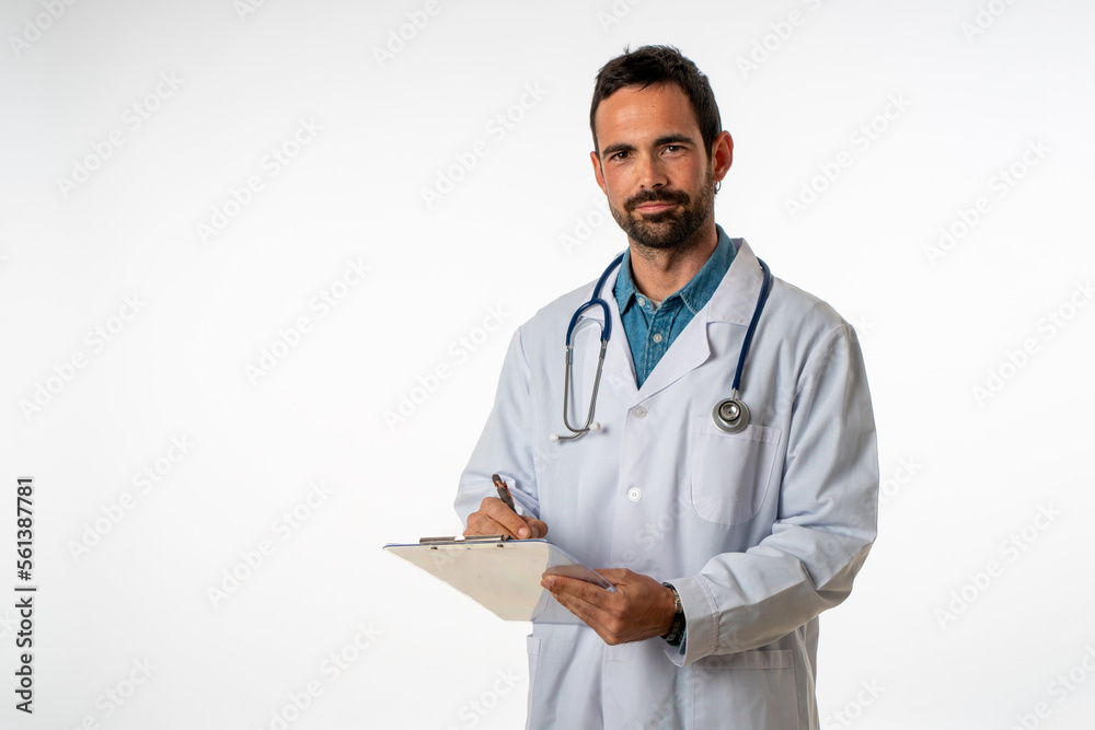 young medical man on white background with gown and stethoscope writing in a folder young medical man on white background with gown and stethoscope writing in a folder