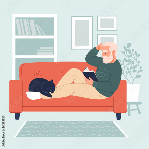 Handsome elderly man sitting on sofa and reading a book