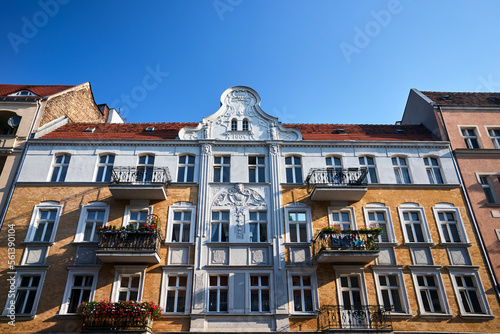historic red brick tenement house with balcony in the city of Poznan