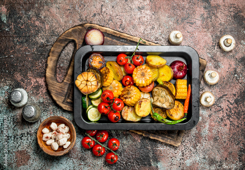 Roasted vegetables and mushrooms grilled in a pan.