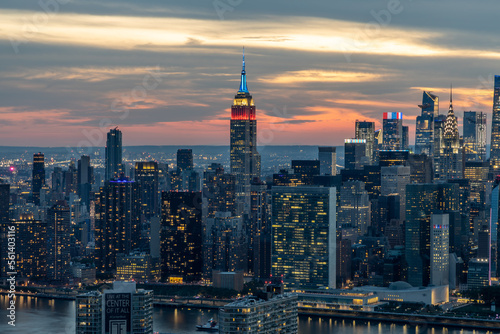 Aerial view of New York City skyline at sunset in patriotic colors Empire State building 