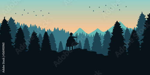 Young adventurer who stood facing the rising sun in the valley of many pines. Looking at the beauty of the beautiful nature and the new beginning of the day. Concept of happiness and personal freedom.