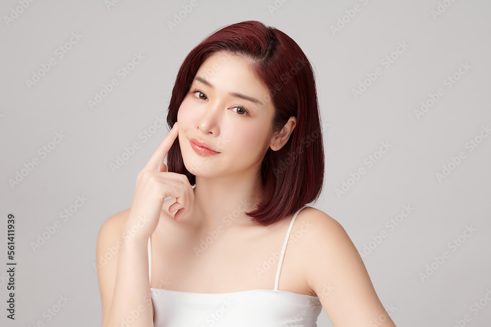 Beautiful young asian woman with clean fresh skin on grey background, Face care, Facial treatment, Cosmetology, beauty and spa, Asian women portrait. Beautiful young asian woman with clean fresh skin on grey background, Face care, Facial treatment, Cosmetology, beauty and spa, Asian women portrait.