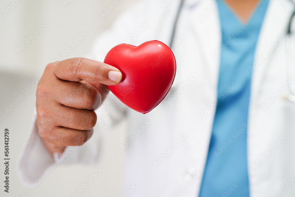 Asian woman doctor holding red heart for health in hospital.. Asian woman doctor holding red heart for health in hospital..