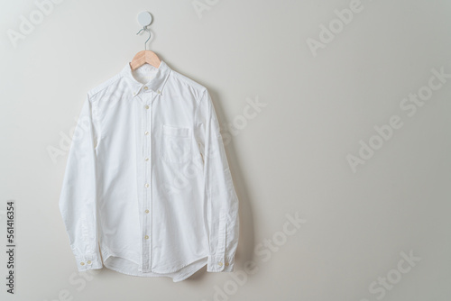 hanging shirt with wood hanger on wall