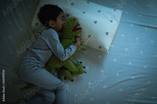 Top View of Asian boy having sweet dreams while Sleeping Cozily Bed photo