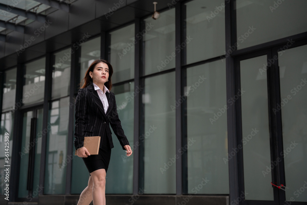 Asian beautiful business woman, she is going to work in the morning on the street in big city. concept of job application. Asian beautiful business woman, she is going to work in the morning on the street in big city. concept of job application.