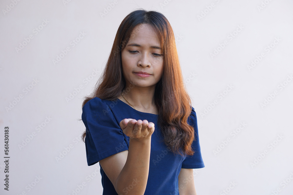 Asian woman extending hand when holding goods Asian woman extending hand when holding goods