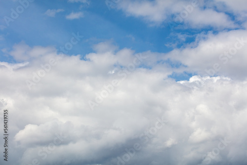 White clouds on the blue sky as a background.