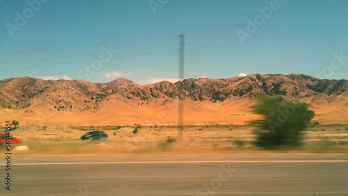 View from car window road trip. Summer day in Kyrgyzstan. Moutnains landscape photo