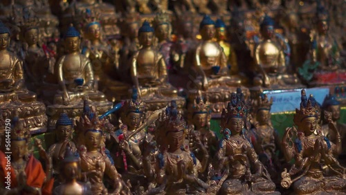 Closeup shot of many small statues of Guru Padmasambhava at Tupchiling Monastery near Tandi in Himachal Pradesh, India. Various statues of Lord buddha inside the monastery. Buddhism background. photo