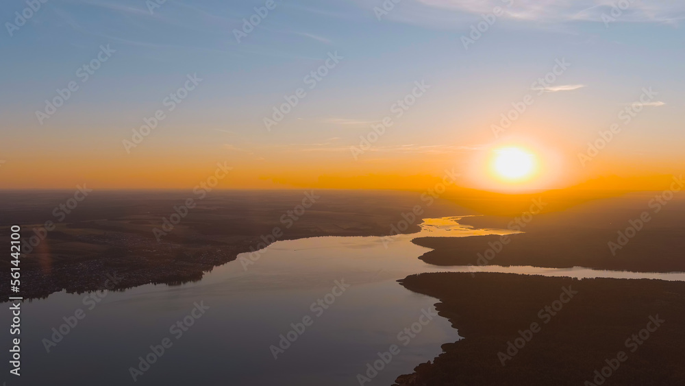 Russia, Votkinsk. The setting sun over the forest and Votkinsk pond. The Votka River and the Sharkan River. Votkinsk city in the Udmurt Republic, Aerial View