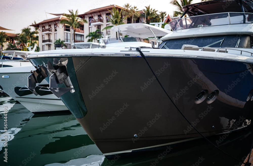 Fototapeta premium Travel, vacation and boat trips. The bow of an expensive luxury yacht on a tropical background.