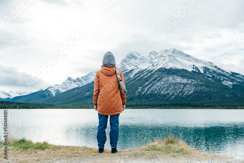 girl standing with her back to the viewer among the mountains banff, canada