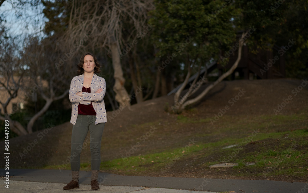 A nonbinary White person expresses themselves outdoors in a femme-presenting manner. A nonbinary White person expresses themselves outdoors in a femme-presenting manner.