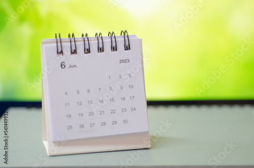 White calendar on green background.