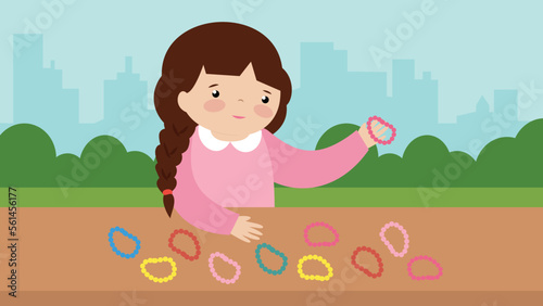 Girl collects colorful rubber bands