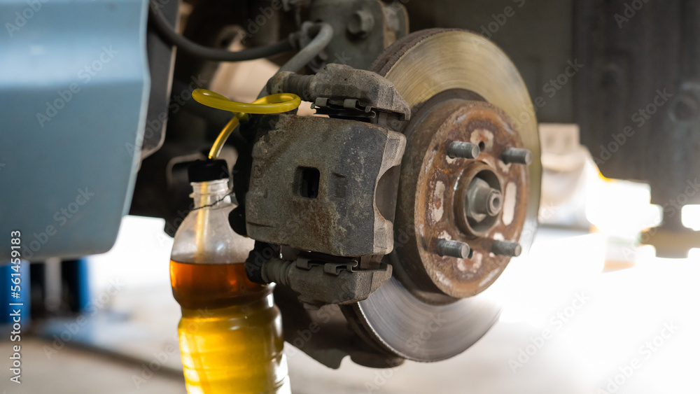 Automatic change of brake fluid in a car service. Stock Photo Adobe Stock