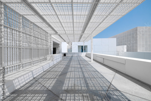 The modern entrance to Abu Dhabi Louvre museum, with a white marble walkway and a geometric square metal grid for shade