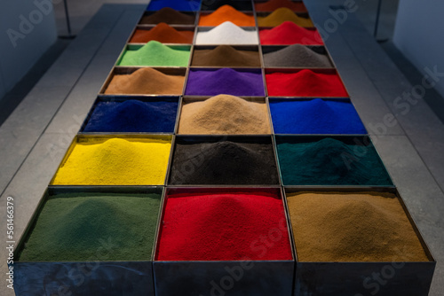 Close up of an array of boxes containing colorful powder