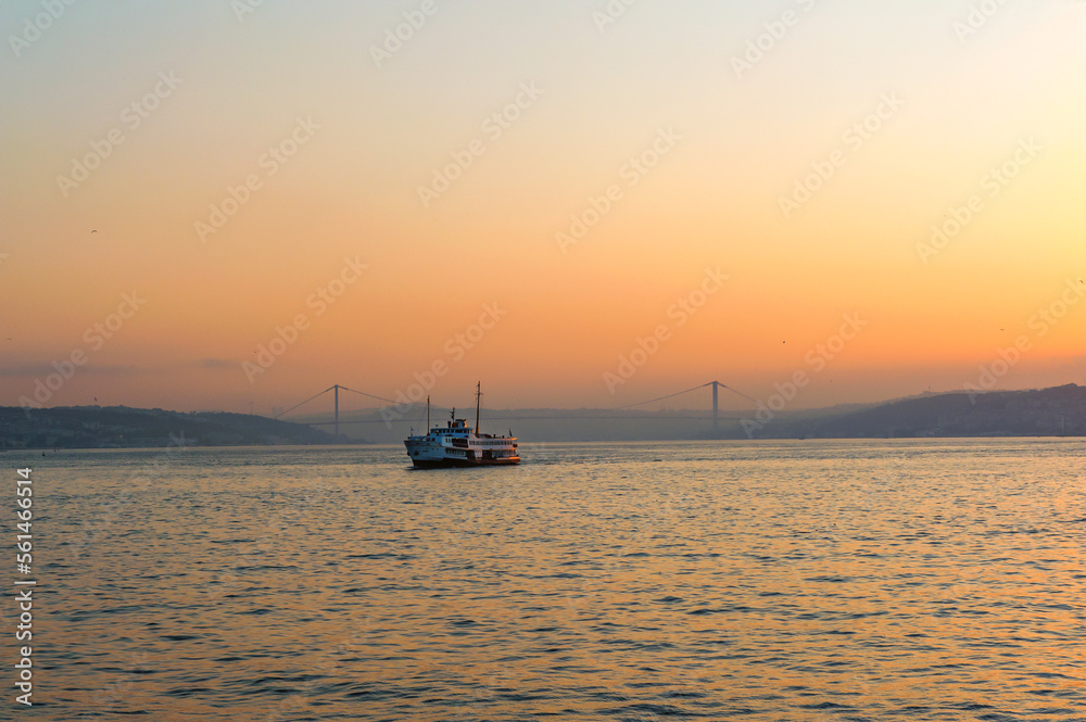 Beautiful misty sunrise over the Bosporus, with the European and Asian shores as a ferry crosses towards Karakoy and Galataport, Turkey